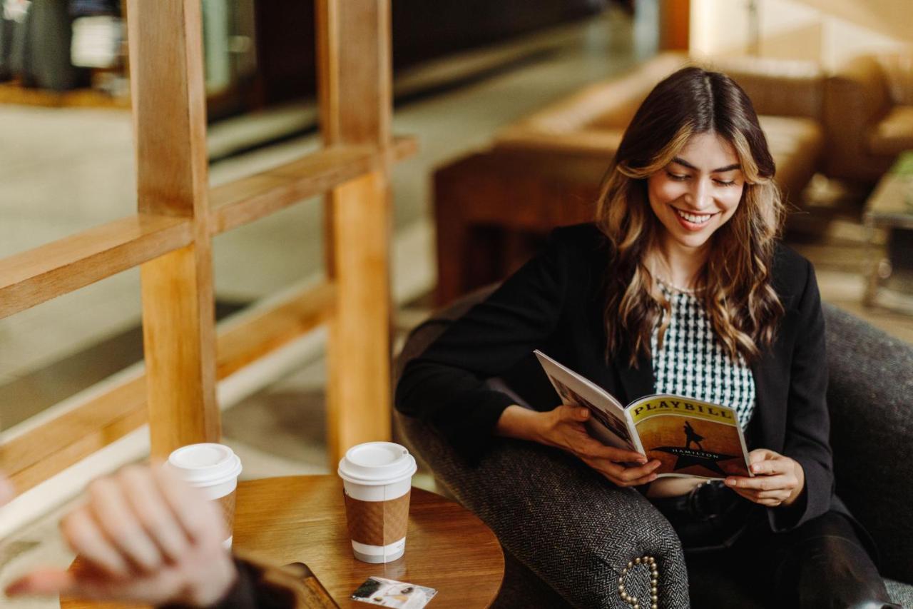 Отель The Westin New York At Times Square Экстерьер фото A woman reading a magazine